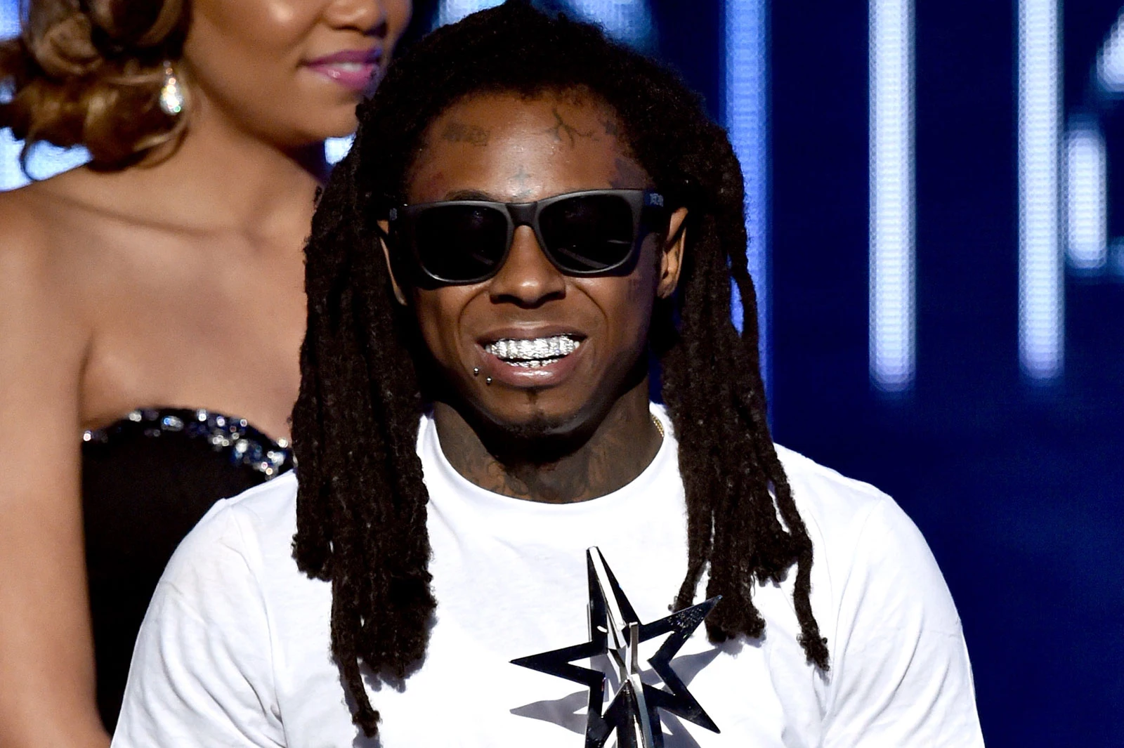 Why did a DJ reveal Lil' Wayne's cell phone number on air?